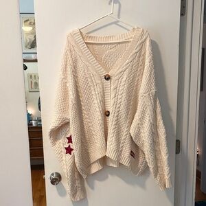 Taylor Swift Cream Cardigan with Red Star Details